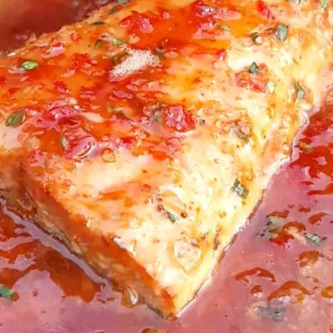 Grilled Salmon with Sweet Chili Glaze - Sweet and spicy. Light and savory. This Grilled Salmon with Sweet Chili Glaze is a perfect example of mixing flavors together, and having them work together perfectly.