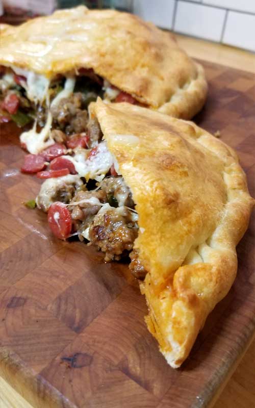 This Meat Lovers Gameday Calzone has all the fixings of a cheesy supreme pizza in a Football Calzone form. Fun to make and even more fun to eat! Perfect for a Super Bowl party or any gameday!