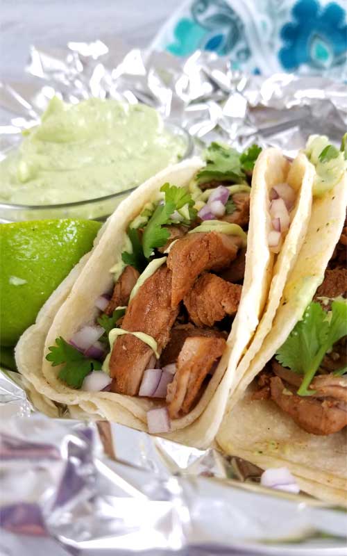 These New Mexico-Style Pork Tacos make for some of the most tender, moist, and flavorful Pork Tacos we've ever had! Complete with a Creamy Avocado Cilantro Lime Dressing to top it off with.