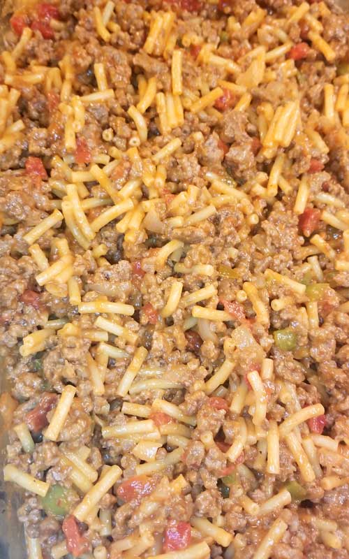 Cooked macaroni and cheese and ground beef for a Mac n Cheesy Cowboy Casserole.