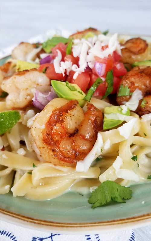 This is a simple, flavorful creation that's ready to party on your plate! Creamy cheesy sauce, buttery shrimp, and Pico De Gallo all make this Creamy Mexican Shrimp Pasta Recipe a love fest for your taste buds!