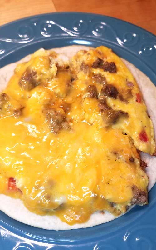 Simple quick easy cheesy, a little bit crispy, and always yummy Breakfast Quesadillas are a nice change of pace for the breakfast table. Well I think they'd be good at lunch or dinner too!