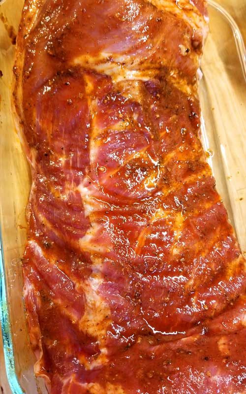 Our spare ribs covered in a smoky ranchero marinade before being cooked.
