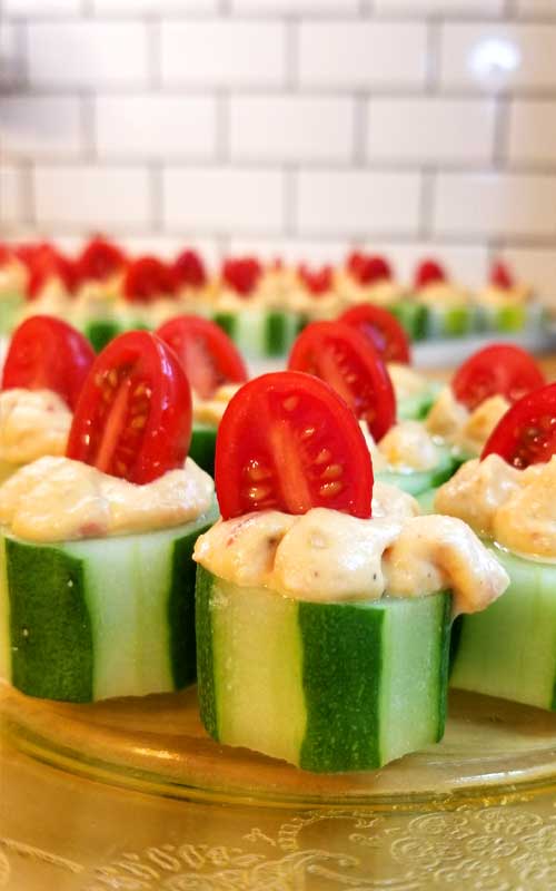 The perfect fresh and flavorful appetizer. These Cucumber Tomato Appetizer Bites are filled with a zesty roasted red pepper hummus, making for a quick and easy dish when entertaining or just a healthy snack.