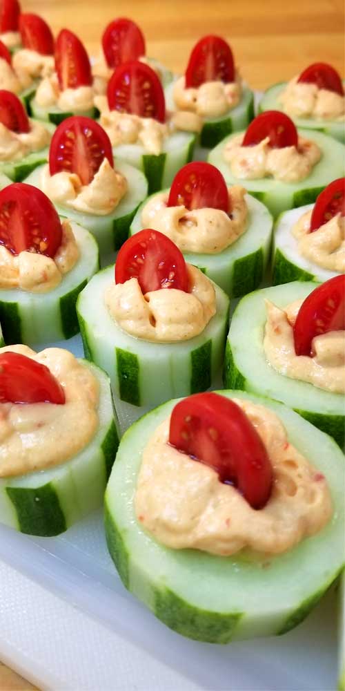 The perfect fresh and flavorful appetizer. These Cucumber Tomato Appetizer Bites are filled with a zesty roasted red pepper hummus, making for a quick and easy dish when entertaining or just a healthy snack.