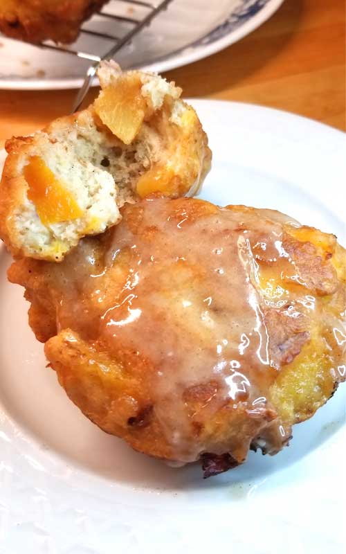 When fresh peaches are at the farmers market, and it's too damn hot to turn the oven on, you make Peach Fritters with Honey Cinnamon Glaze!