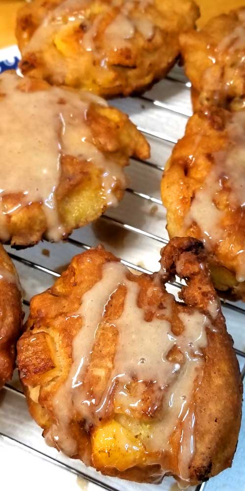 When fresh peaches are at the farmers market, and it's too damn hot to turn the oven on, you make Peach Fritters with Honey Cinnamon Glaze!