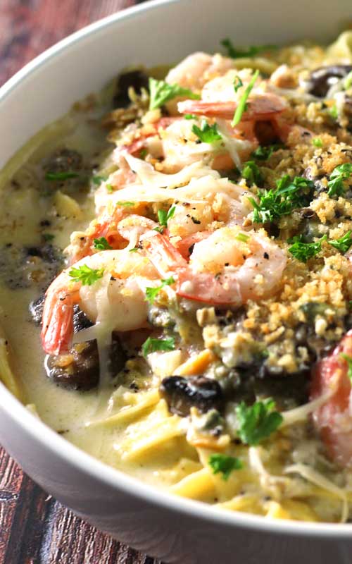 When shrimp, crab, clams, and mushrooms come together in a luscious creamy, cheesy garlic sauce over fresh pasta, you get this delectable Seafood Alfredo Fettuccine!