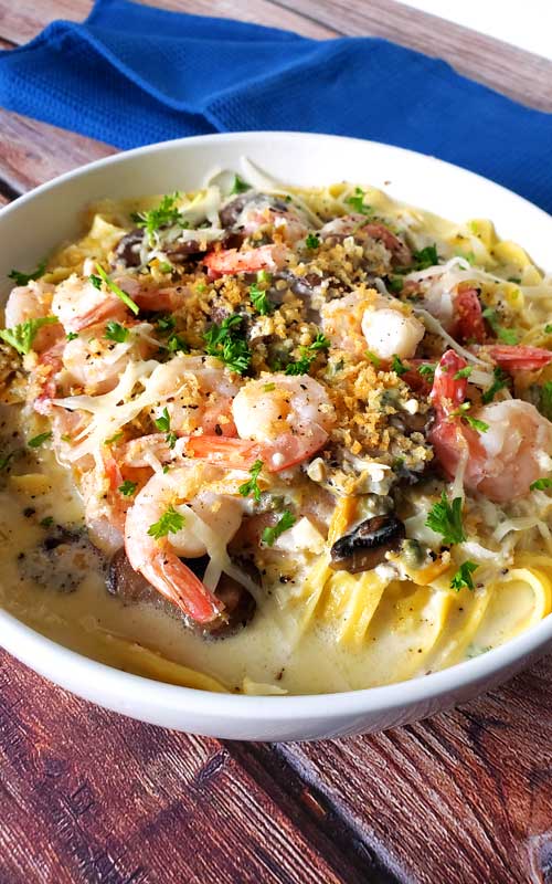 When shrimp, crab, clams, and mushrooms come together in a luscious creamy, cheesy garlic sauce over fresh pasta, you get this delectable Seafood Alfredo Fettuccine!