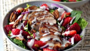 Prepared Summer Chicken and Strawberry salad in a white bowl.