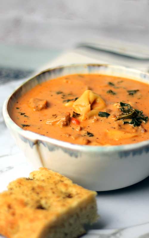 Creamy Sausage Tortellini Soup is one of my all time favorite soups. The flavors are amazing for such a simple easy recipe and it has everything you need for a big bowl of comfort.