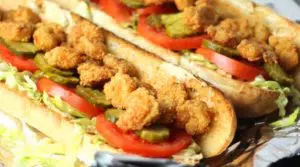 The Shrimp Po'Boy is the king of New Orleans sandwiches! French bread spilling over with shrimp, lettuce, tomato, and a homemade rémoulade sauce.
